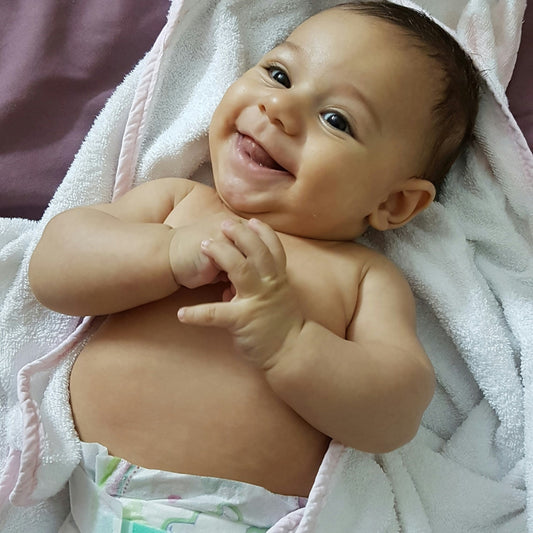 Smiling baby is waiting to change diaper